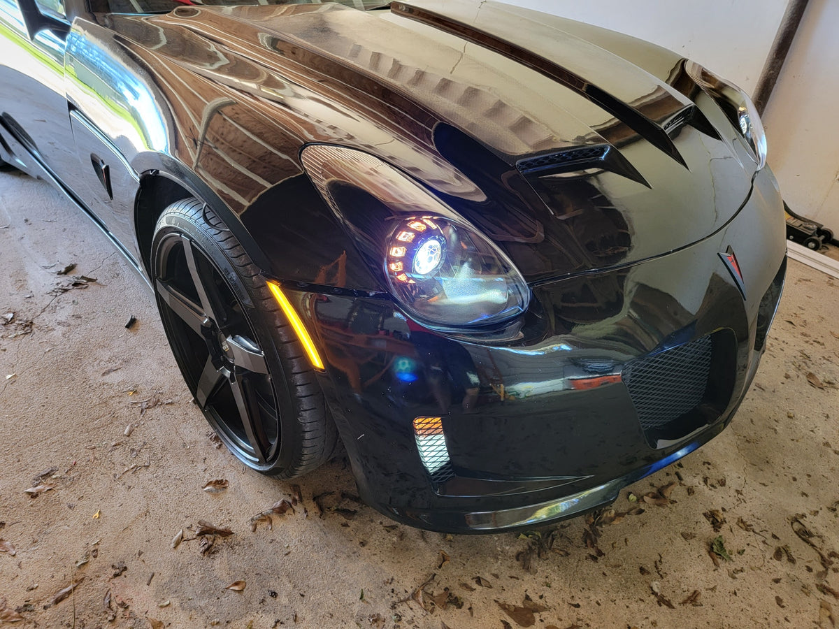 Black Pontiac Solstice with white halo headlights