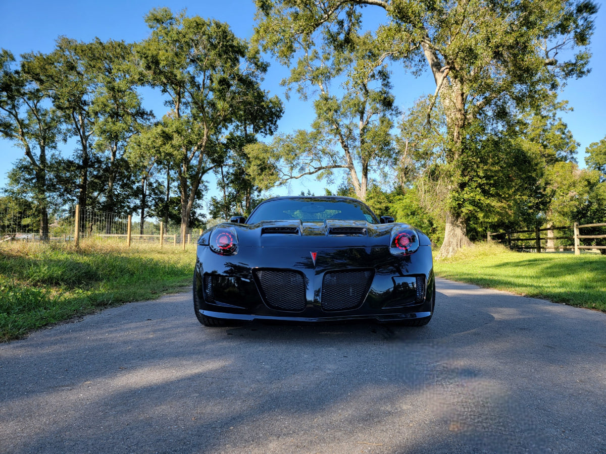 Black Pontiac Solstice with Purple halo headlights